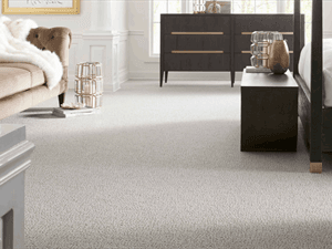 Neutral textured patterned berber broadloom carpet installed wall-to-wall in a spacious bedroom suite