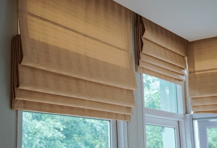 Linen Flat-Fold Roman Shades - Window Coverings by Deluxe in Toronto Residence. Clean-lined flat fold Roman shades in natural oatmeal linen, offering timeless texture and tailored light control.