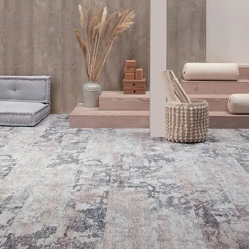Commercial-grade textured modular carpet tiles laid in an alternating pattern