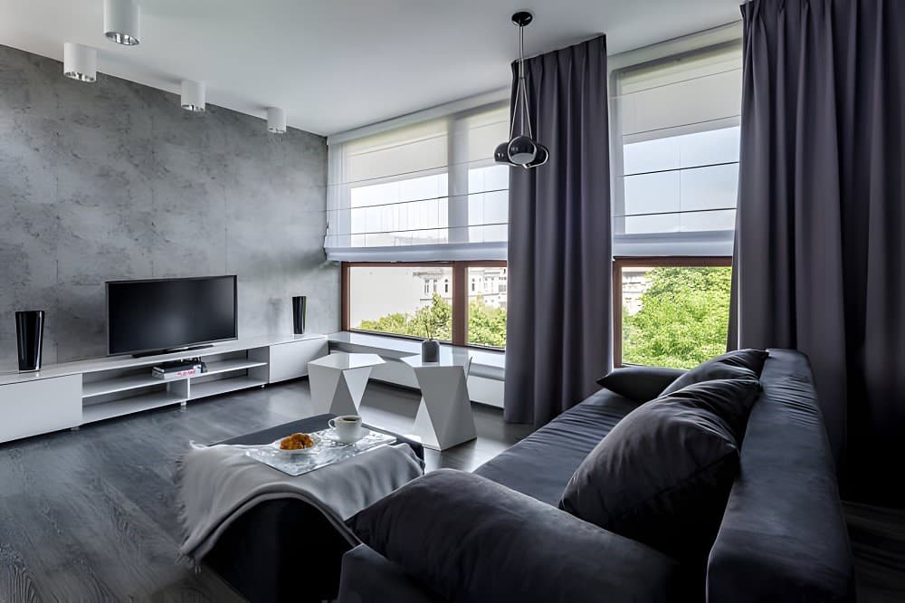 Pinch-Pleat Linen Drapes - Window Coverings by Deluxe in Calgary Residence. Handcrafted classic three-finger pinch pleat drapes hung on custom architectural hardware for refined formal elegance.