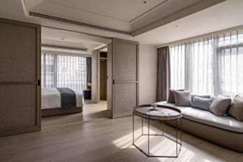Ceiling-recessed commercial ripplefold drapery in executive lounge reception