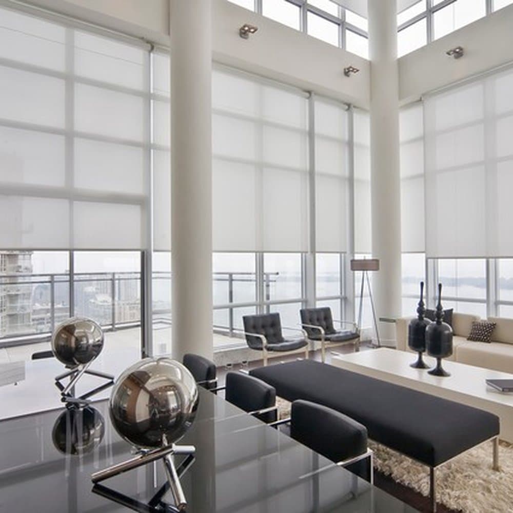 Corner executive office featuring motorized solar screen roller shades