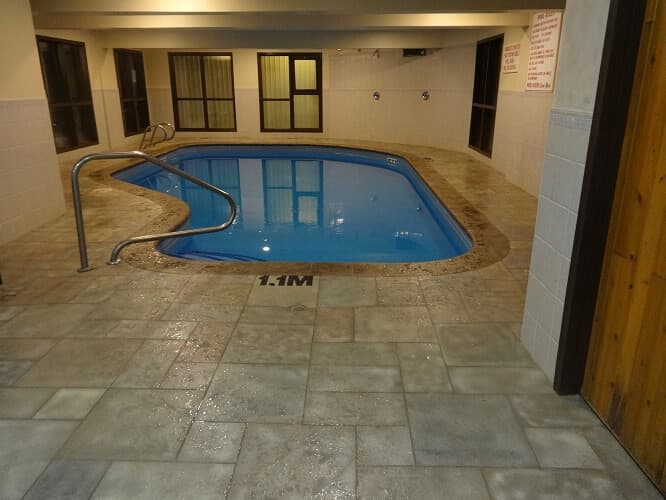 Indoor heated swimming pool with textured Aris Stone coping and slip-resistant deck tiles